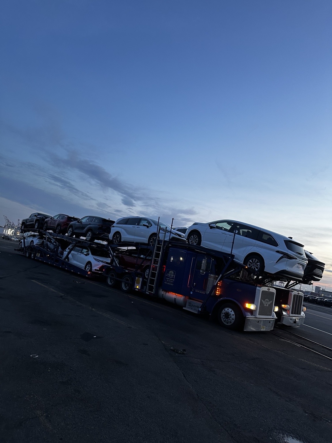 Loaded Golden Auto Transport car carrier at dusk