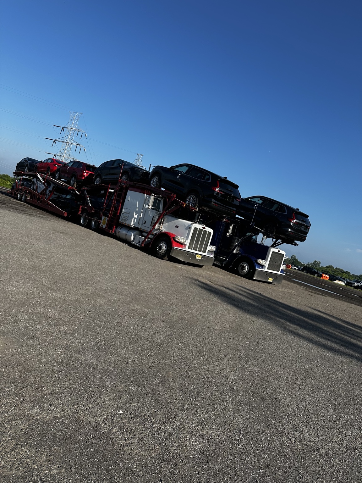 Two Golden Auto Transport loaded car carriers